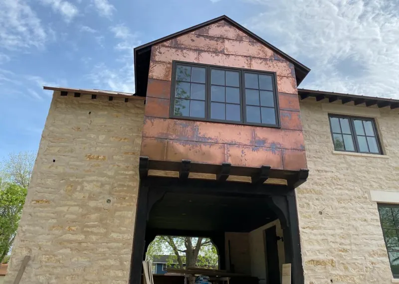Copper metal panel facade on a stone building for Metal Roof Coating in Manvel